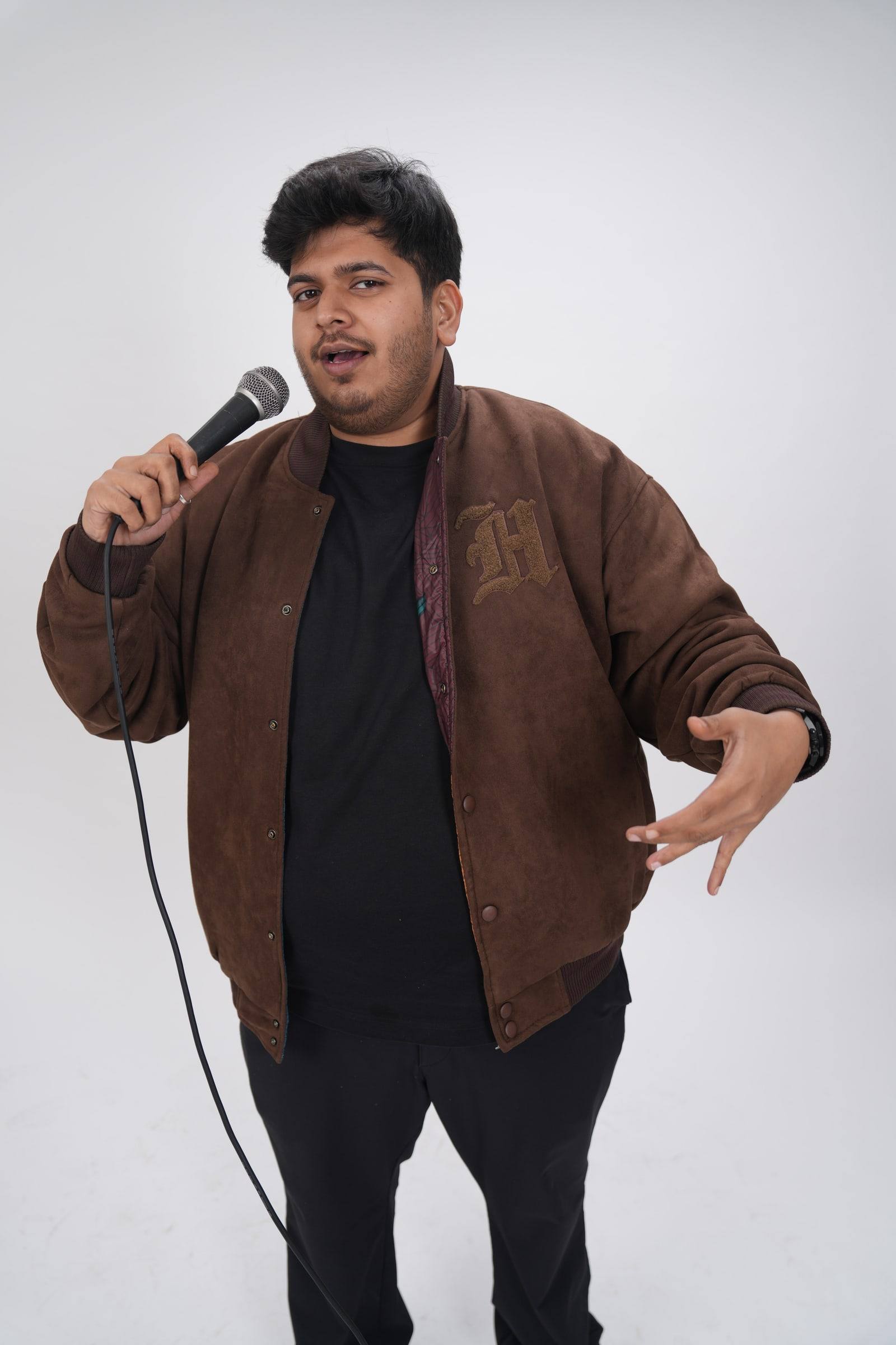 Kaustubh Agarwal mid-sentence, gesturing with an open hand